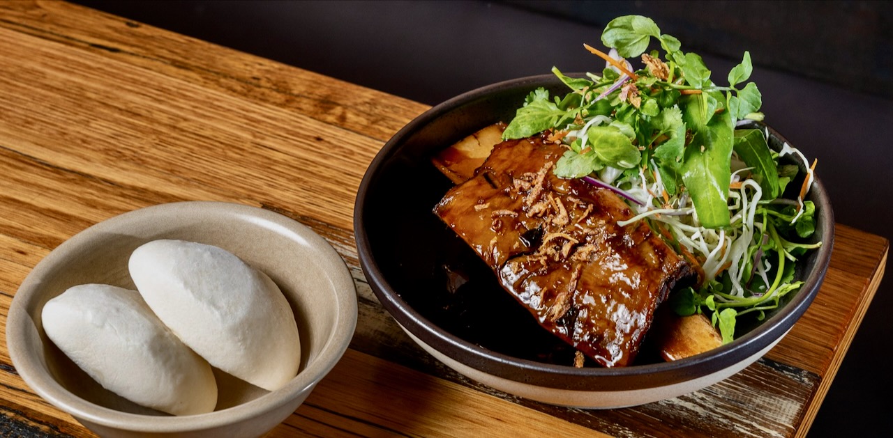 Slow-cooked beef short ribs with steamed buns