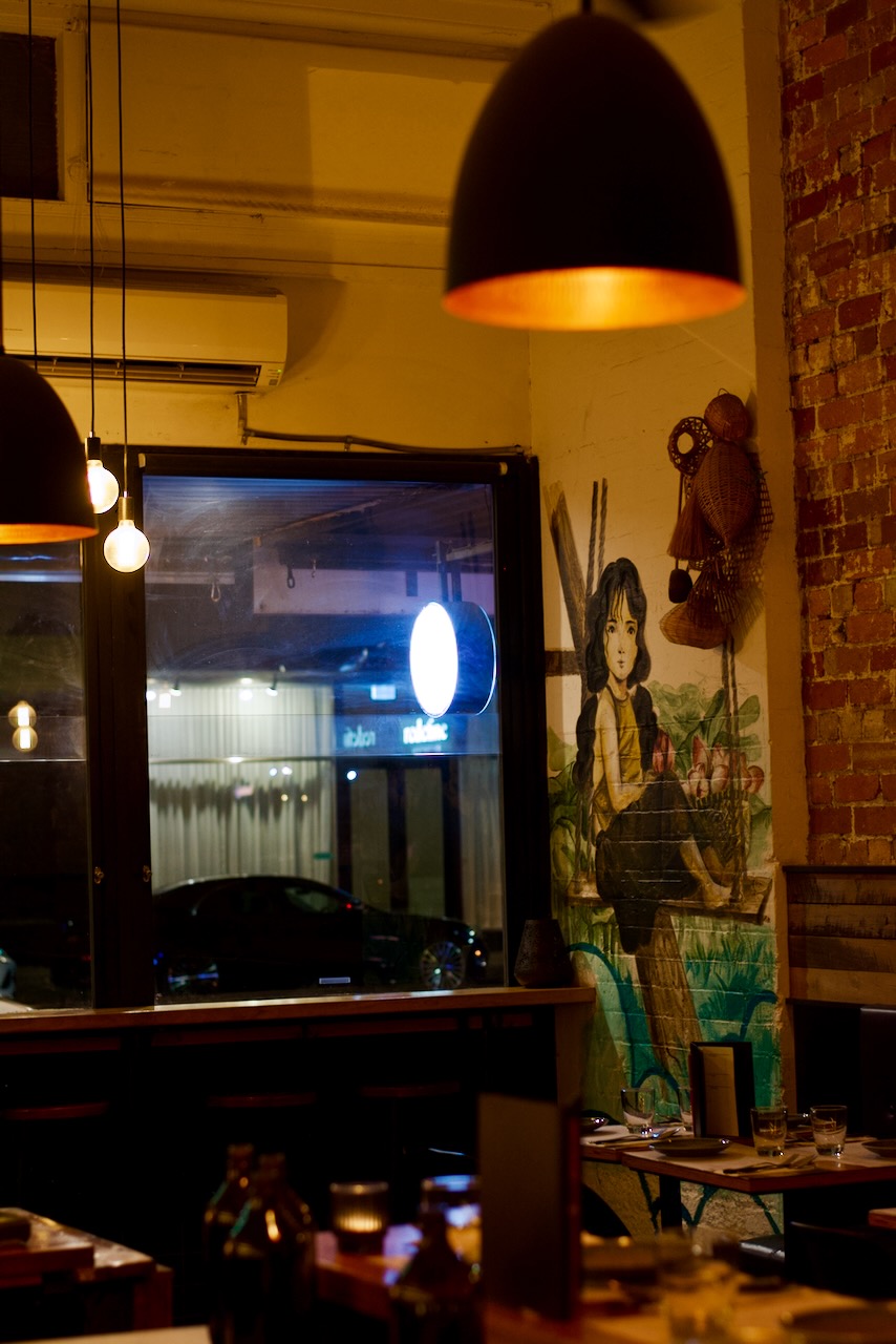 The warmly lit dining room at Paper Plate Restaurant near the MCG in Richmond