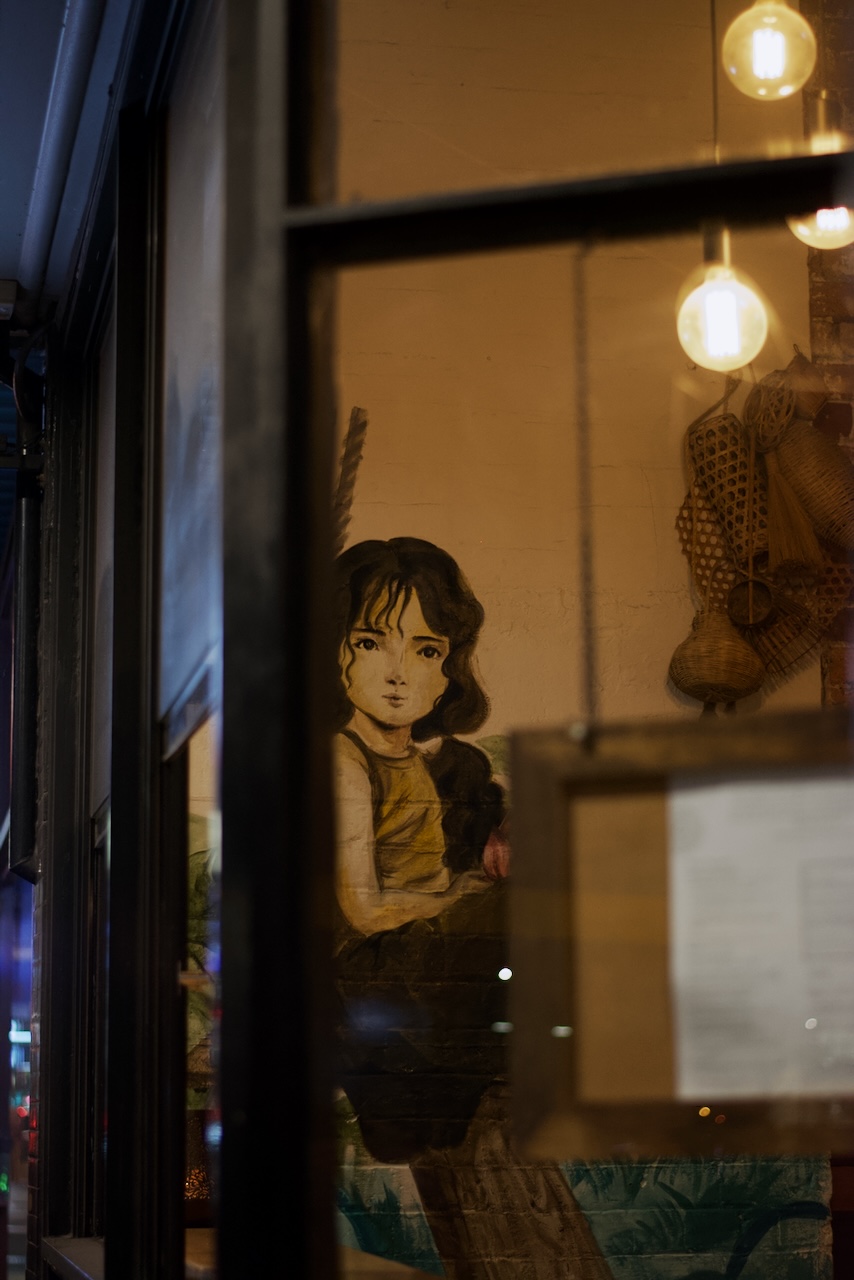 Paper Plate's hand-painted interior mural seen through the window